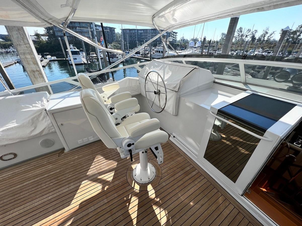 a white robot on a wooden platform aboard 2001 BROWARD RAISED PILOTHOUSE MY Yacht for Sale