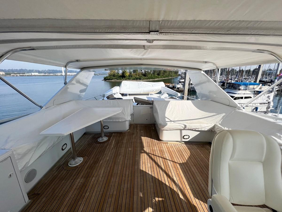 a deck with a deck and a view of the water aboard 2001 BROWARD RAISED PILOTHOUSE MY Yacht for Sale