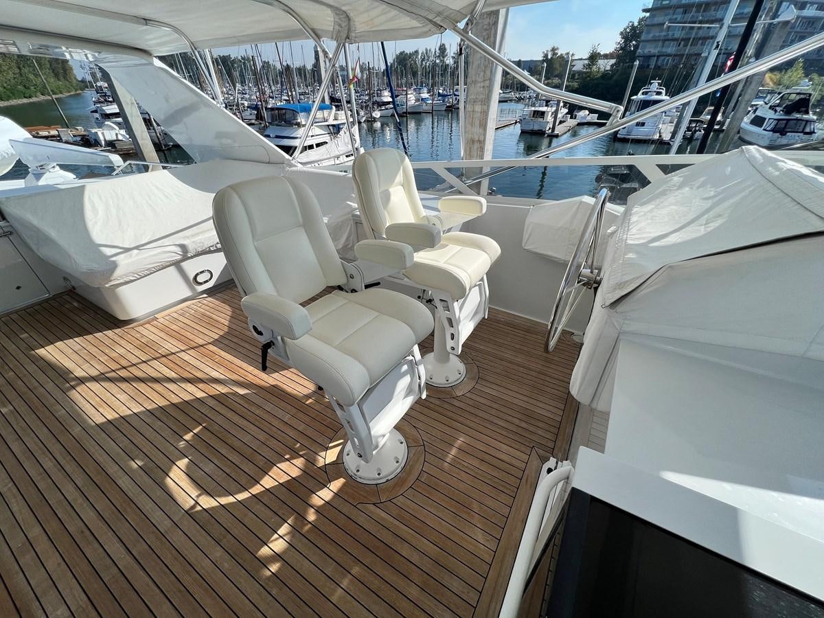 a deck with a deck and chairs on it aboard 2001 BROWARD RAISED PILOTHOUSE MY Yacht for Sale