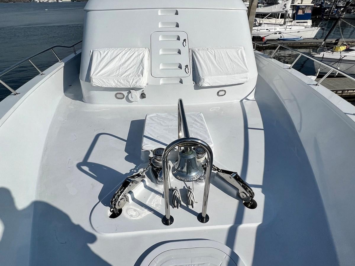 a white boat with a steering wheel aboard 2001 BROWARD RAISED PILOTHOUSE MY Yacht for Sale
