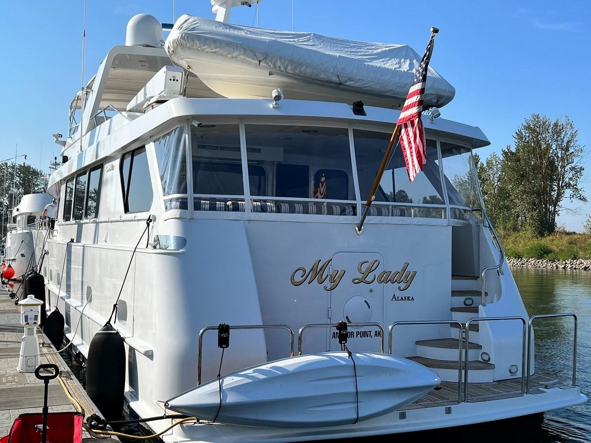 a boat with a flag on the front aboard 2001 BROWARD RAISED PILOTHOUSE MY Yacht for Sale