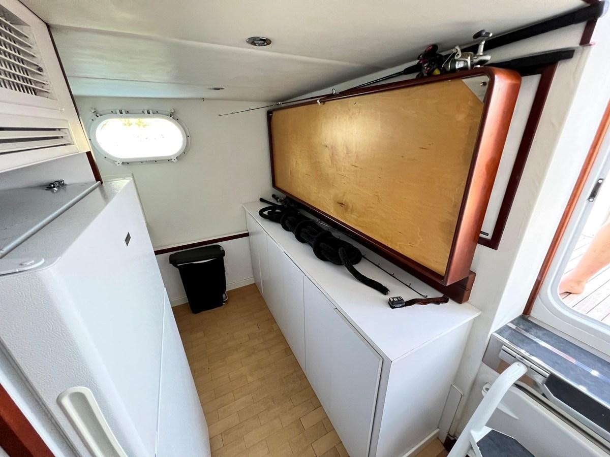 a stove with a wood top aboard 2001 BROWARD RAISED PILOTHOUSE MY Yacht for Sale