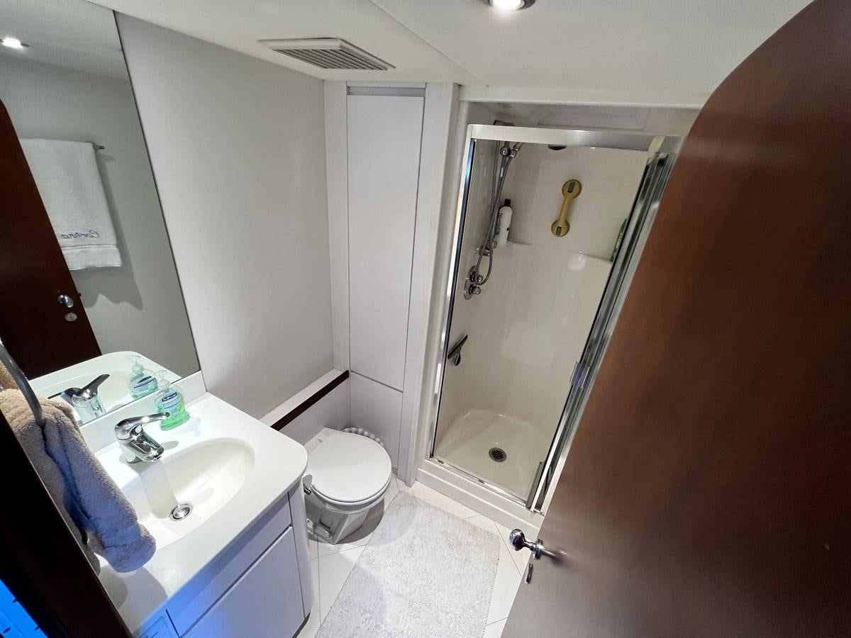 a bathroom with a toilet and sink aboard 2001 BROWARD RAISED PILOTHOUSE MY Yacht for Sale