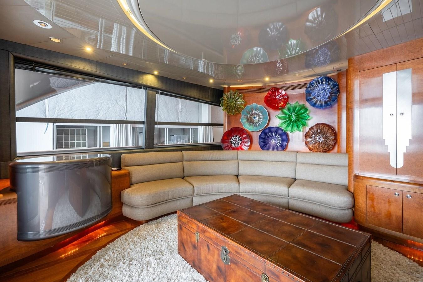 a living room with a couch and a tv aboard 1996 ADMIRAL MARINE 71 Yacht for Sale
