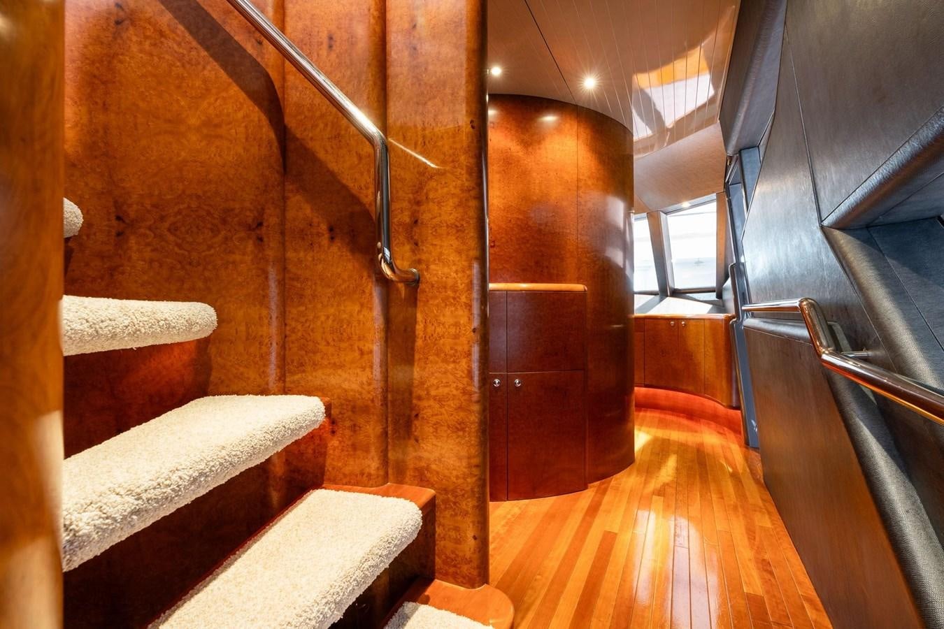 a wooden staircase with wood floors aboard 1996 ADMIRAL MARINE 71 Yacht for Sale