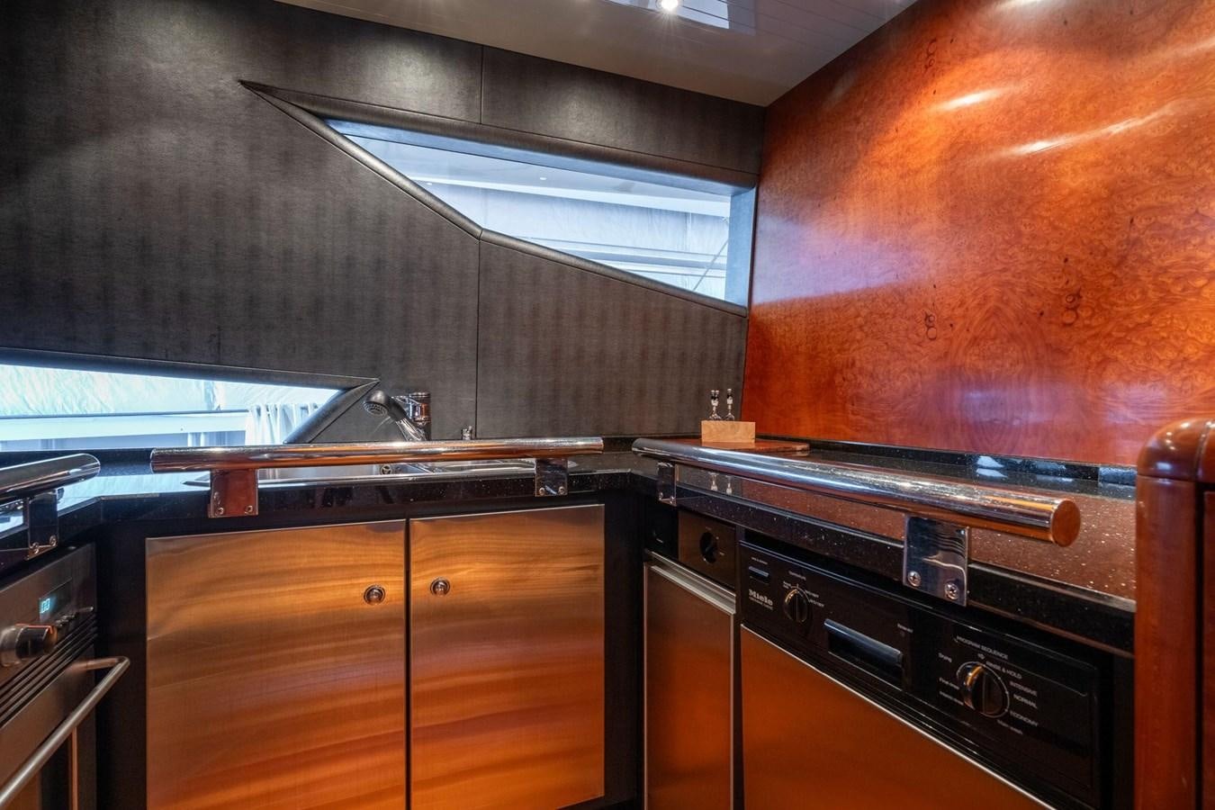 a kitchen with wooden cabinets aboard 1996 ADMIRAL MARINE 71 Yacht for Sale