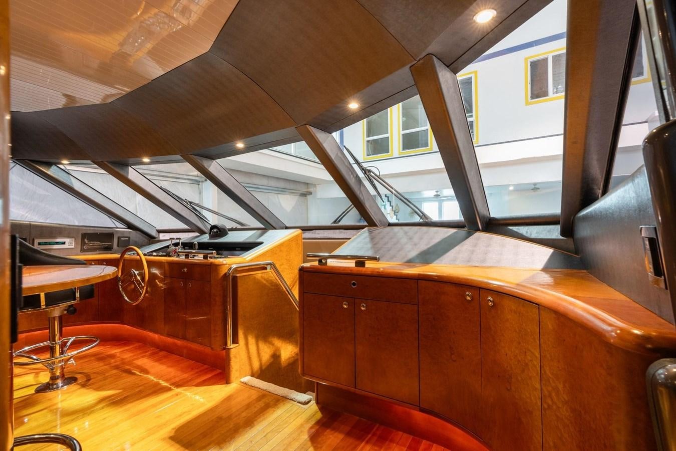 a room with a wood desk and a large window aboard 1996 ADMIRAL MARINE 71 Yacht for Sale