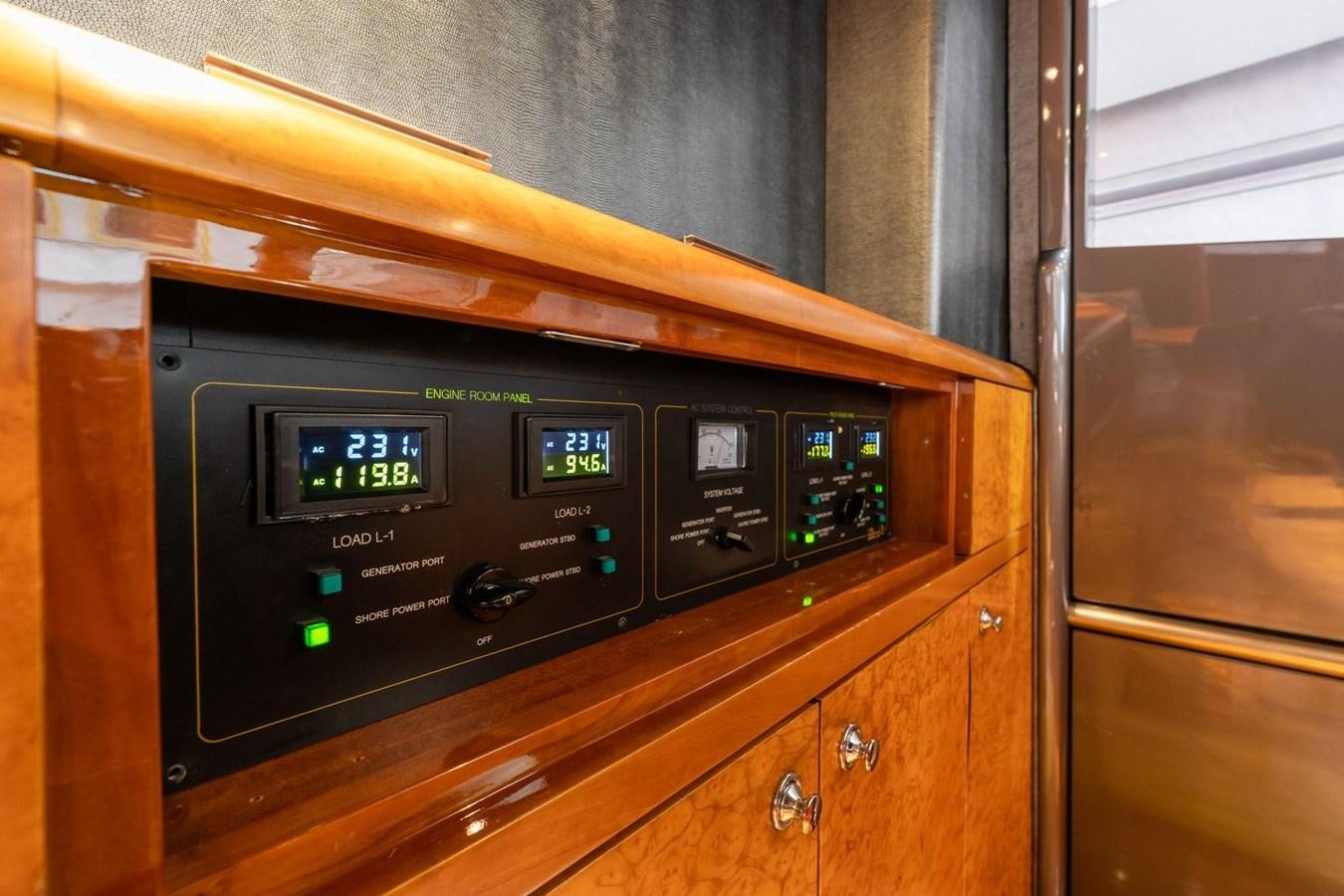 a black digital clock on a wooden cabinet aboard 1996 ADMIRAL MARINE 71 Yacht for Sale
