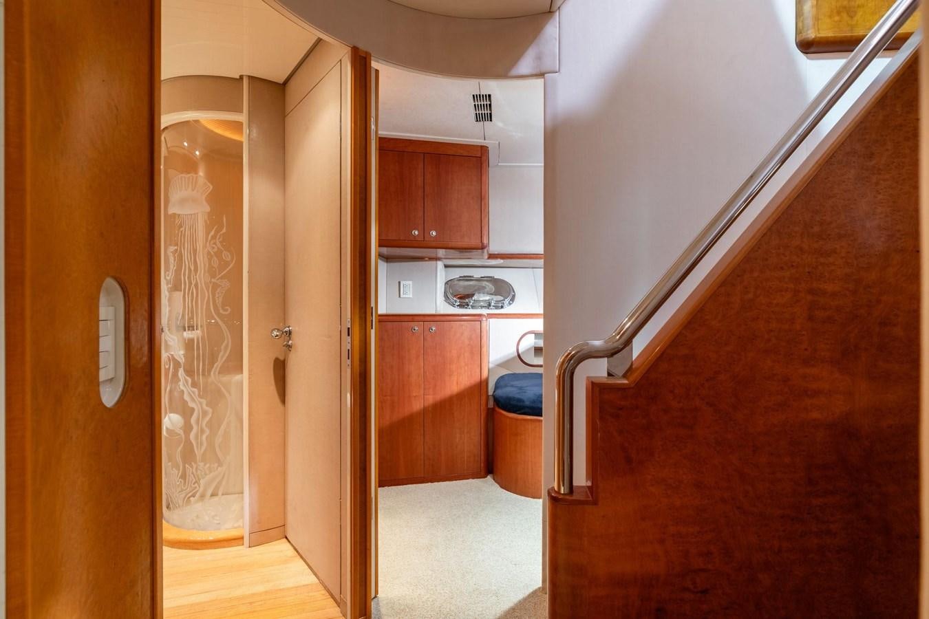 a room with a wood door and a wood cabinet aboard 1996 ADMIRAL MARINE 71 Yacht for Sale
