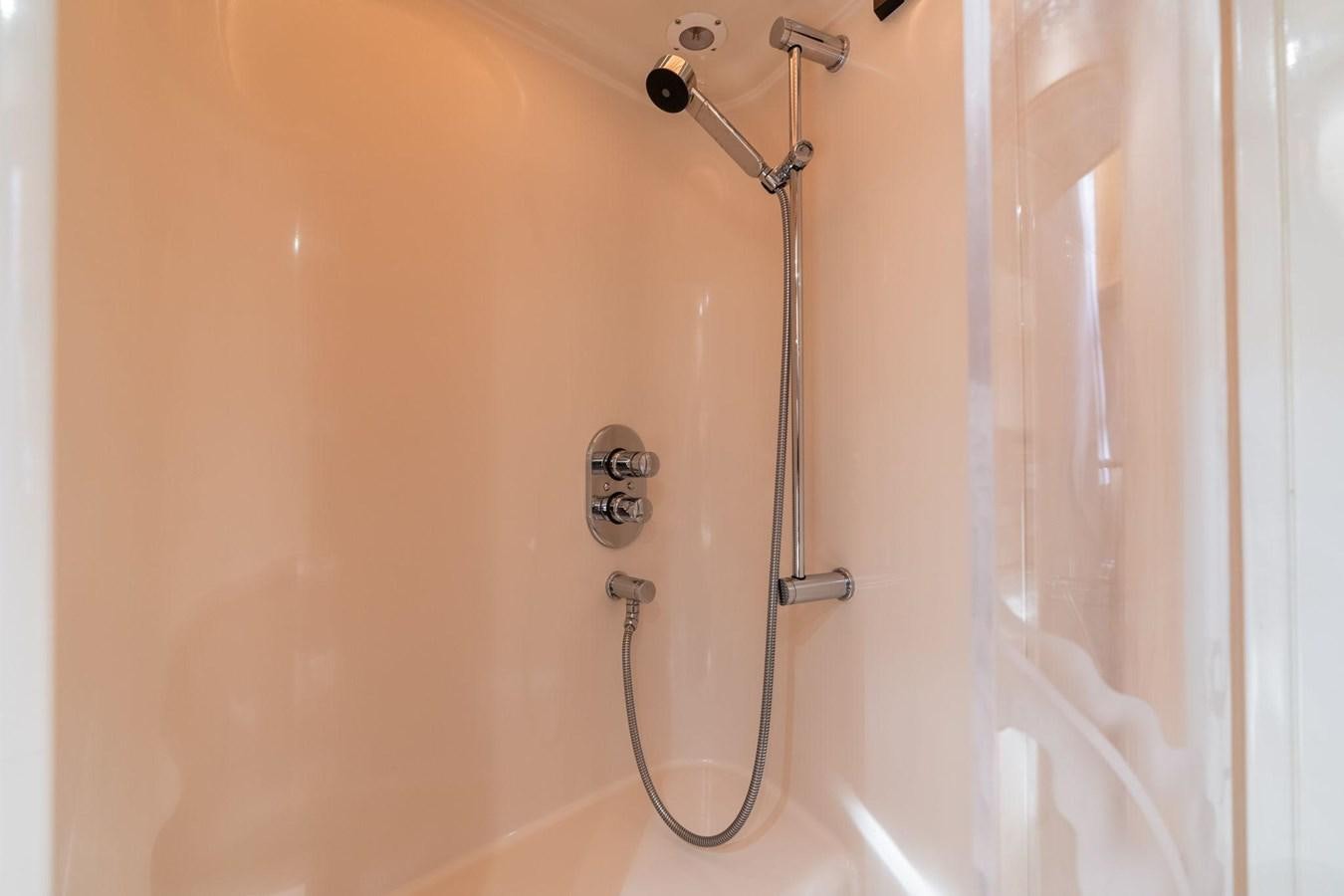 a shower with a white curtain aboard 1996 ADMIRAL MARINE 71 Yacht for Sale