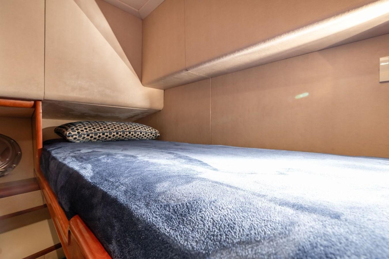 a bed with a blue comforter aboard 1996 ADMIRAL MARINE 71 Yacht for Sale