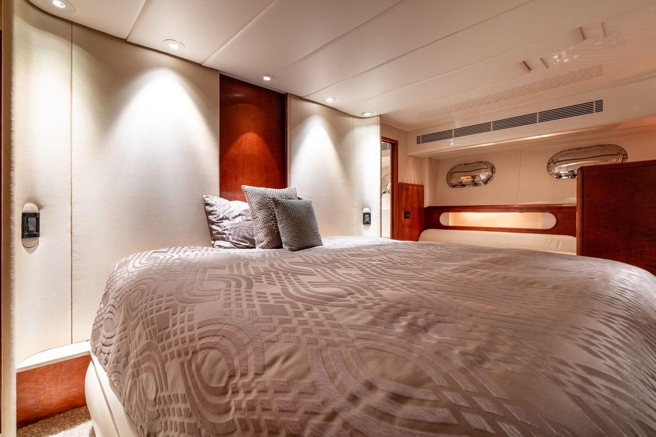 a bed with a white comforter aboard 1996 ADMIRAL MARINE 71 Yacht for Sale