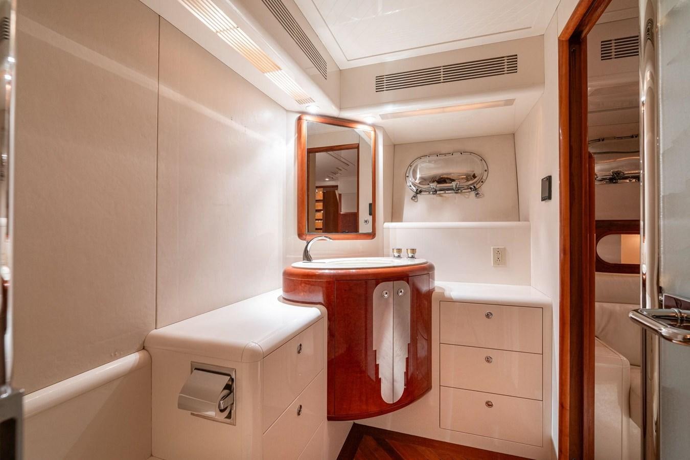 a small bathroom with a red sink aboard 1996 ADMIRAL MARINE 71 Yacht for Sale