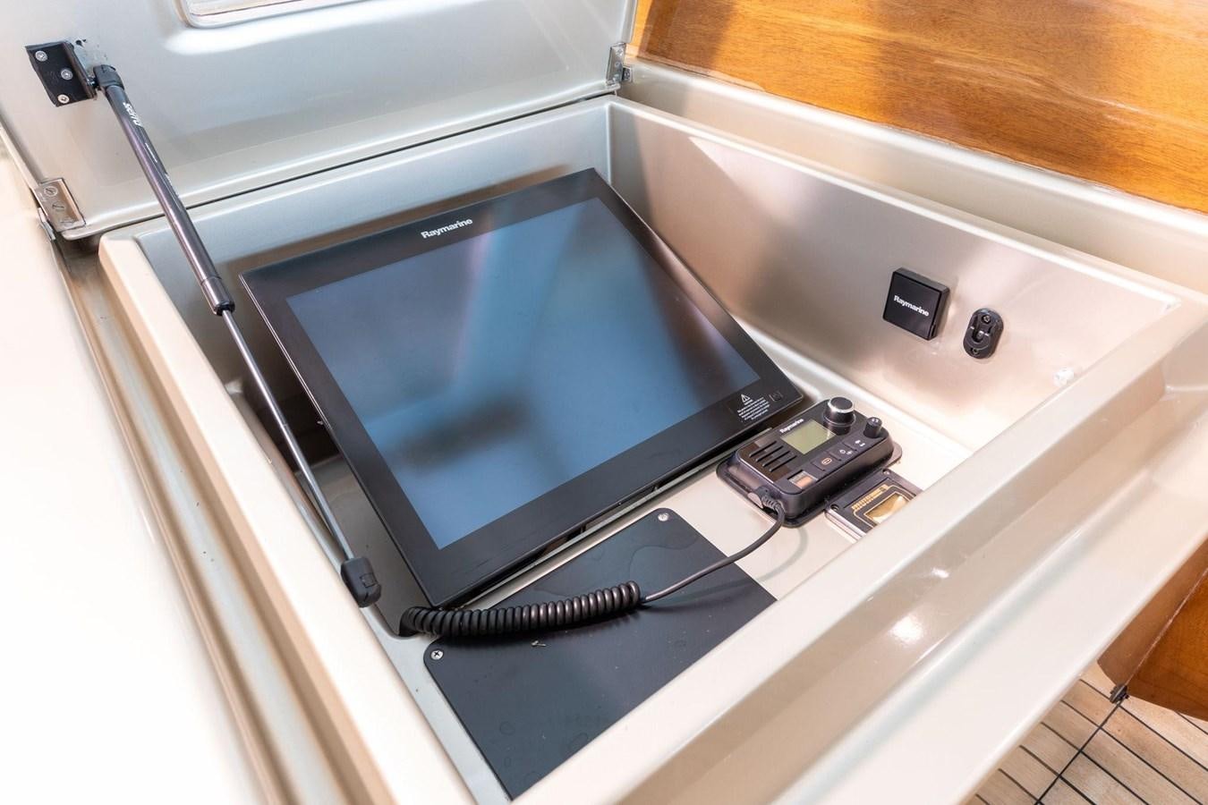a silver television on a white table aboard 1996 ADMIRAL MARINE 71 Yacht for Sale