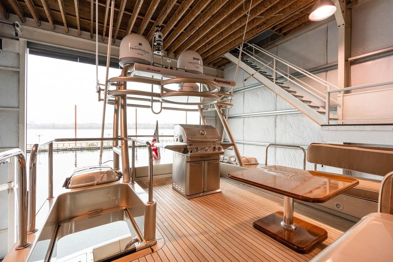 a room with tables and chairs aboard 1996 ADMIRAL MARINE 71 Yacht for Sale