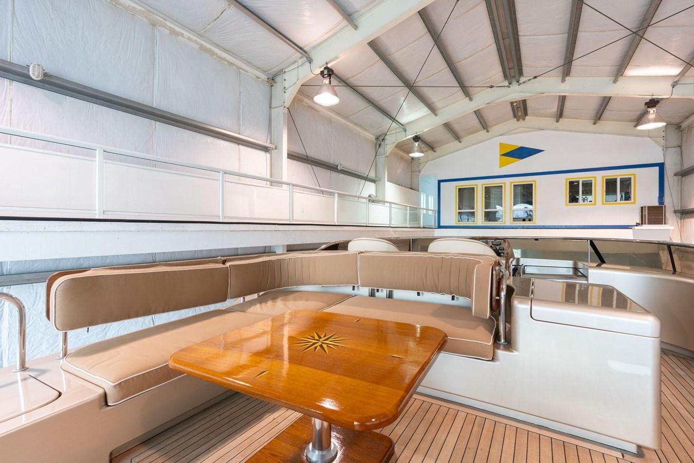 a large kitchen with a table aboard 1996 ADMIRAL MARINE 71 Yacht for Sale