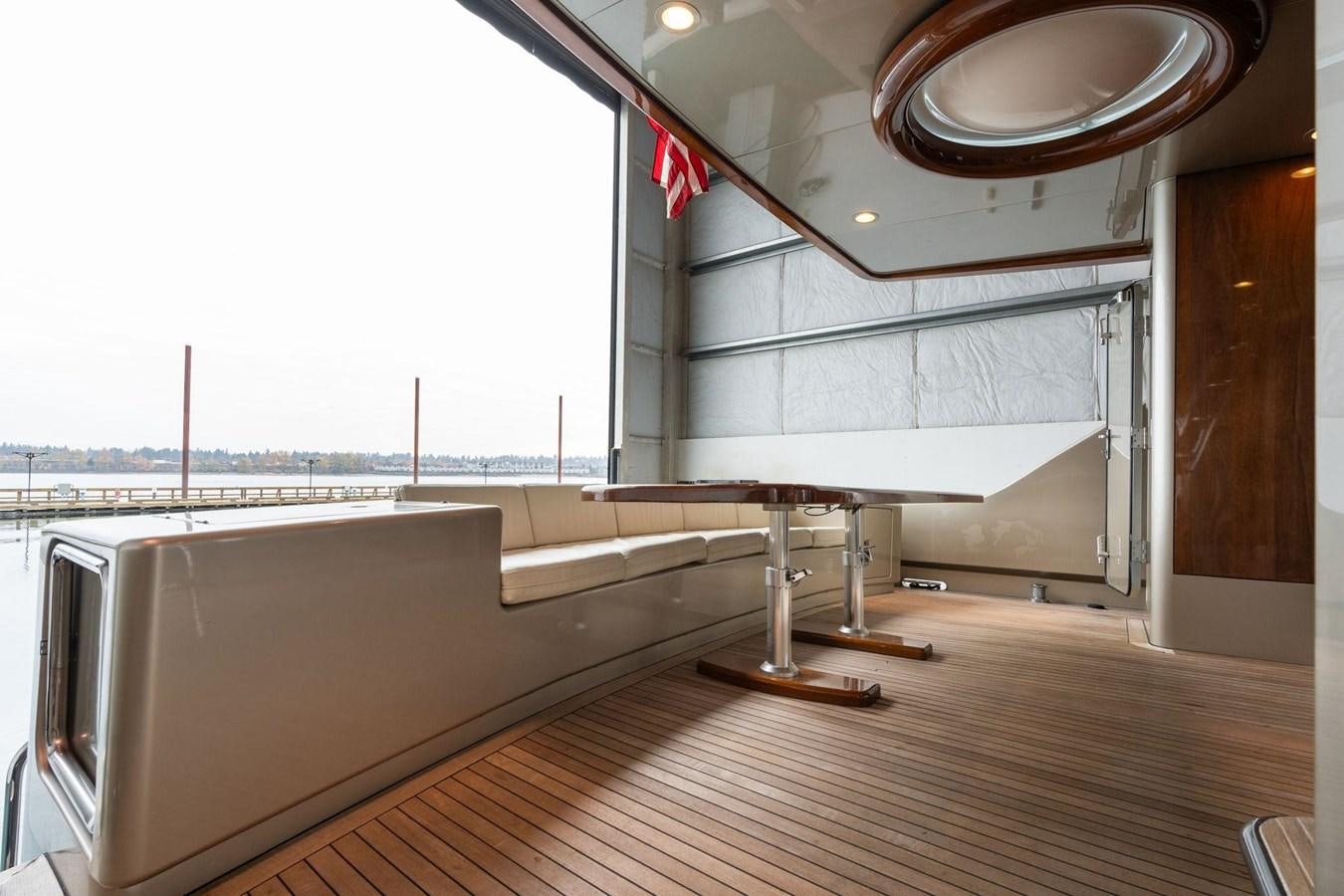 a room with a wood floor and a large window with a red flag aboard 1996 ADMIRAL MARINE 71 Yacht for Sale