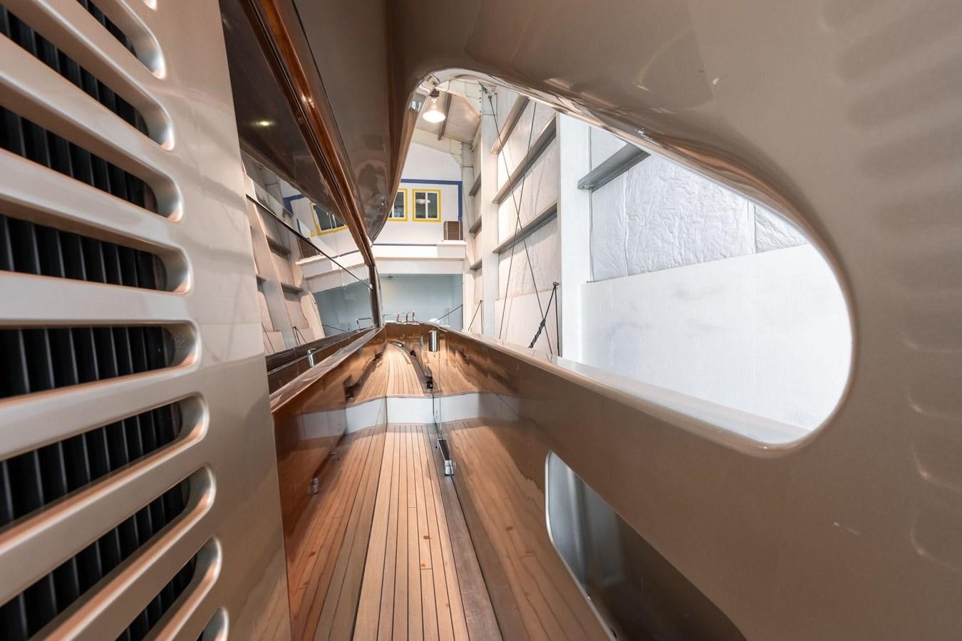 a wooden staircase with a glass window aboard 1996 ADMIRAL MARINE 71 Yacht for Sale