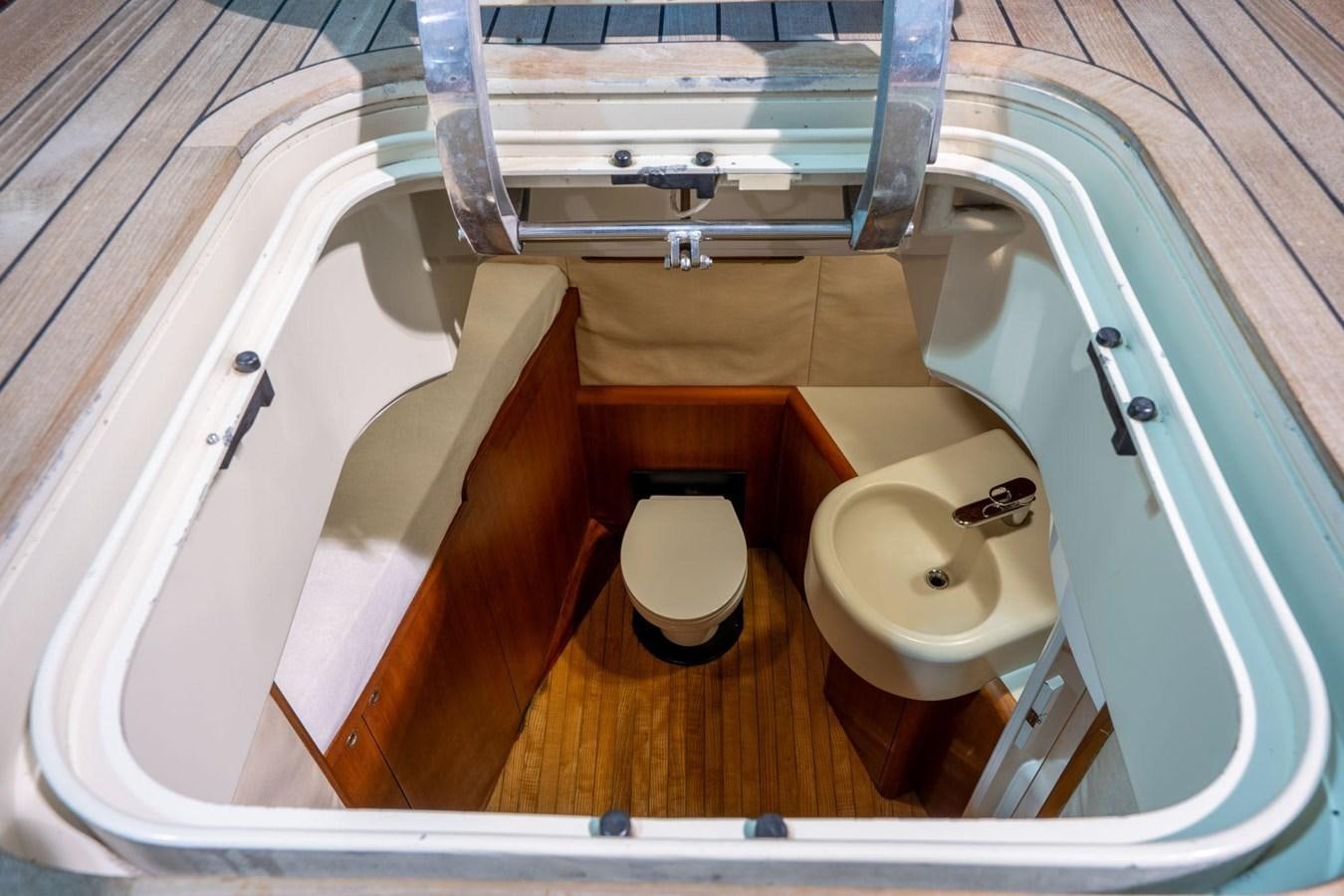 a bathroom with a toilet and a sink aboard 1996 ADMIRAL MARINE 71 Yacht for Sale
