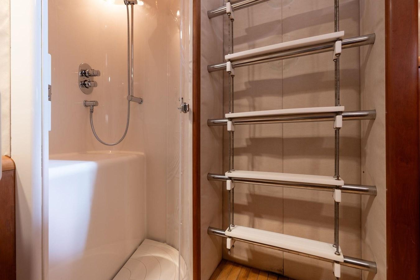 a bathroom with a white tub and a white toilet aboard 1996 ADMIRAL MARINE 71 Yacht for Sale