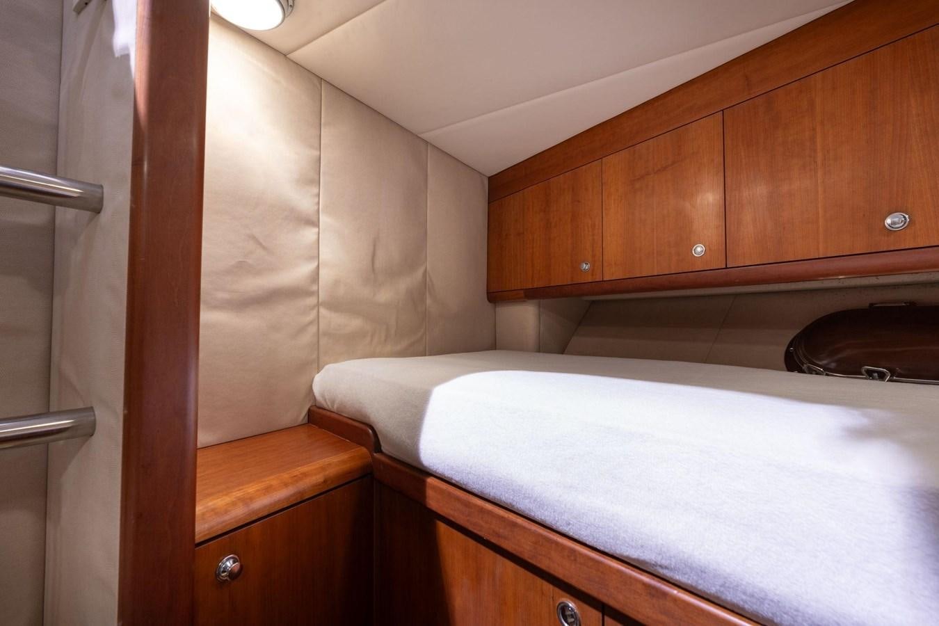 a room with a bed and cabinets aboard 1996 ADMIRAL MARINE 71 Yacht for Sale