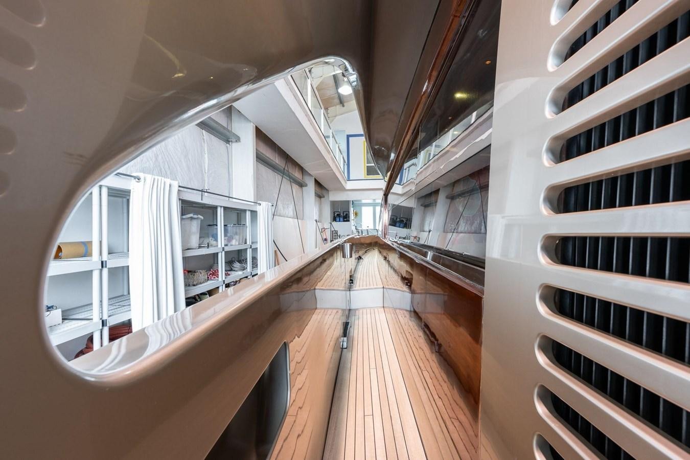 a long wooden staircase aboard 1996 ADMIRAL MARINE 71 Yacht for Sale