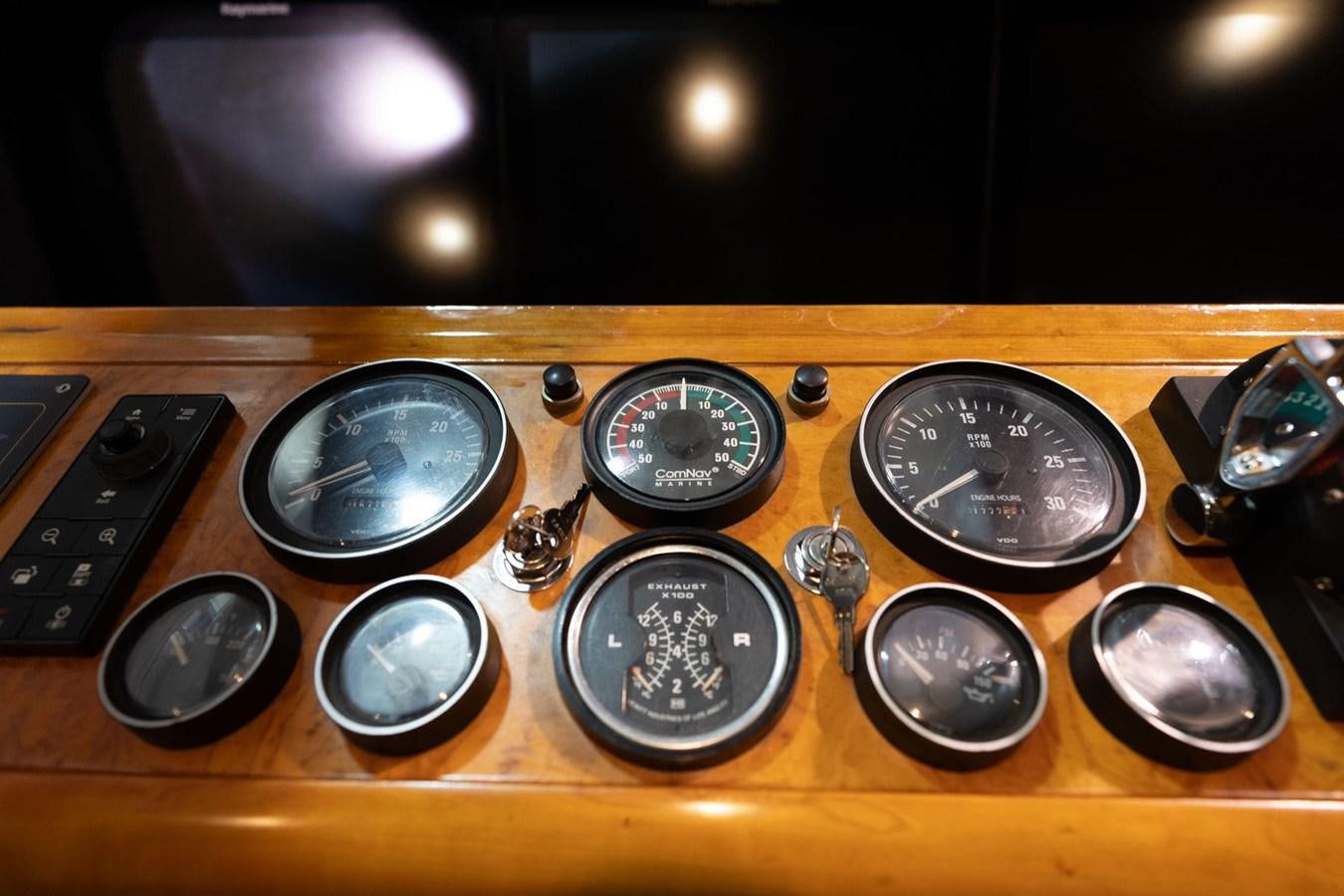 a group of music instruments on a wooden table aboard 1996 ADMIRAL MARINE 71 Yacht for Sale
