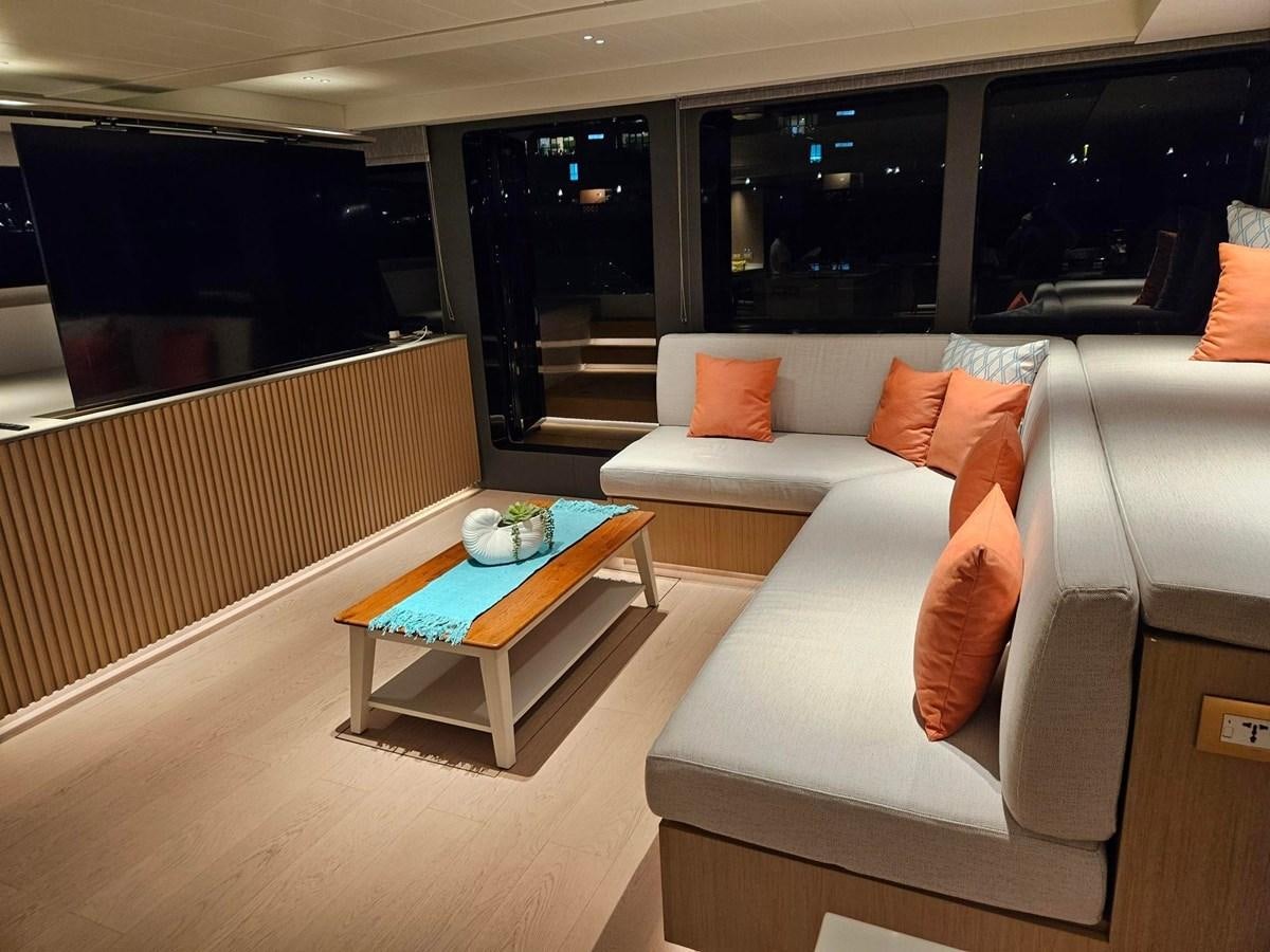 a living room with a couch and a coffee table aboard BUNDALONG Yacht for Sale