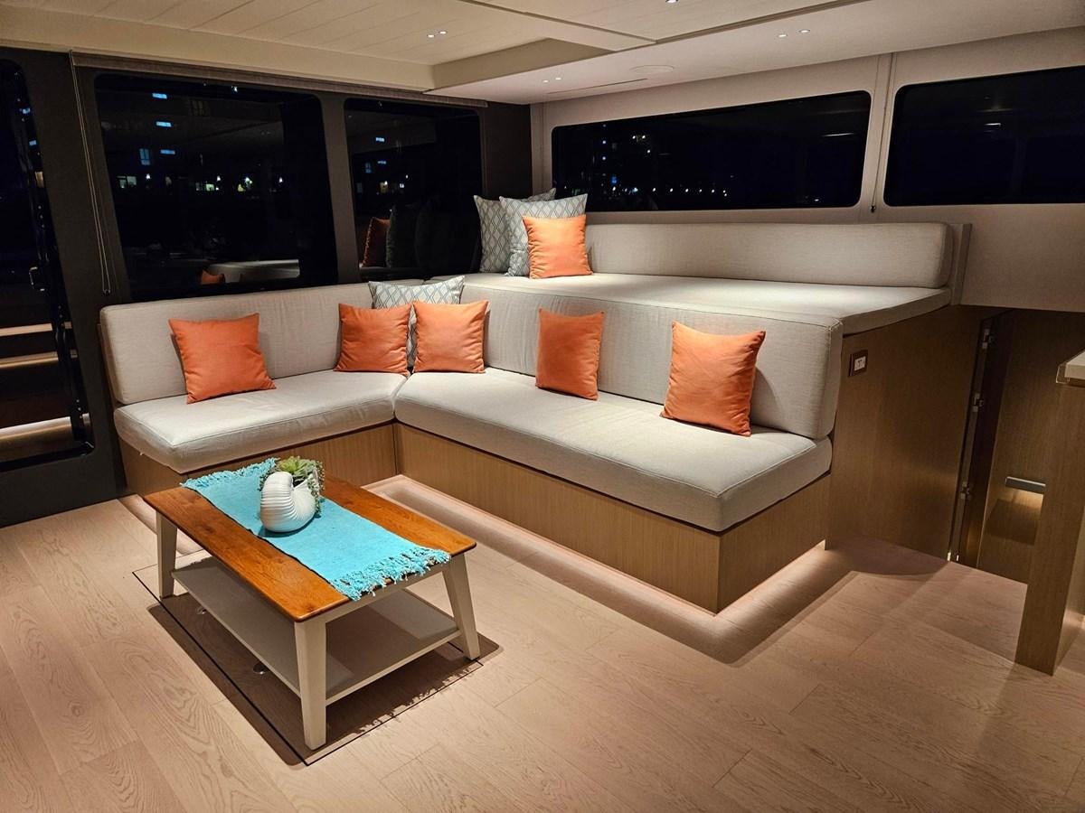 a white couch with orange pillows aboard BUNDALONG Yacht for Sale
