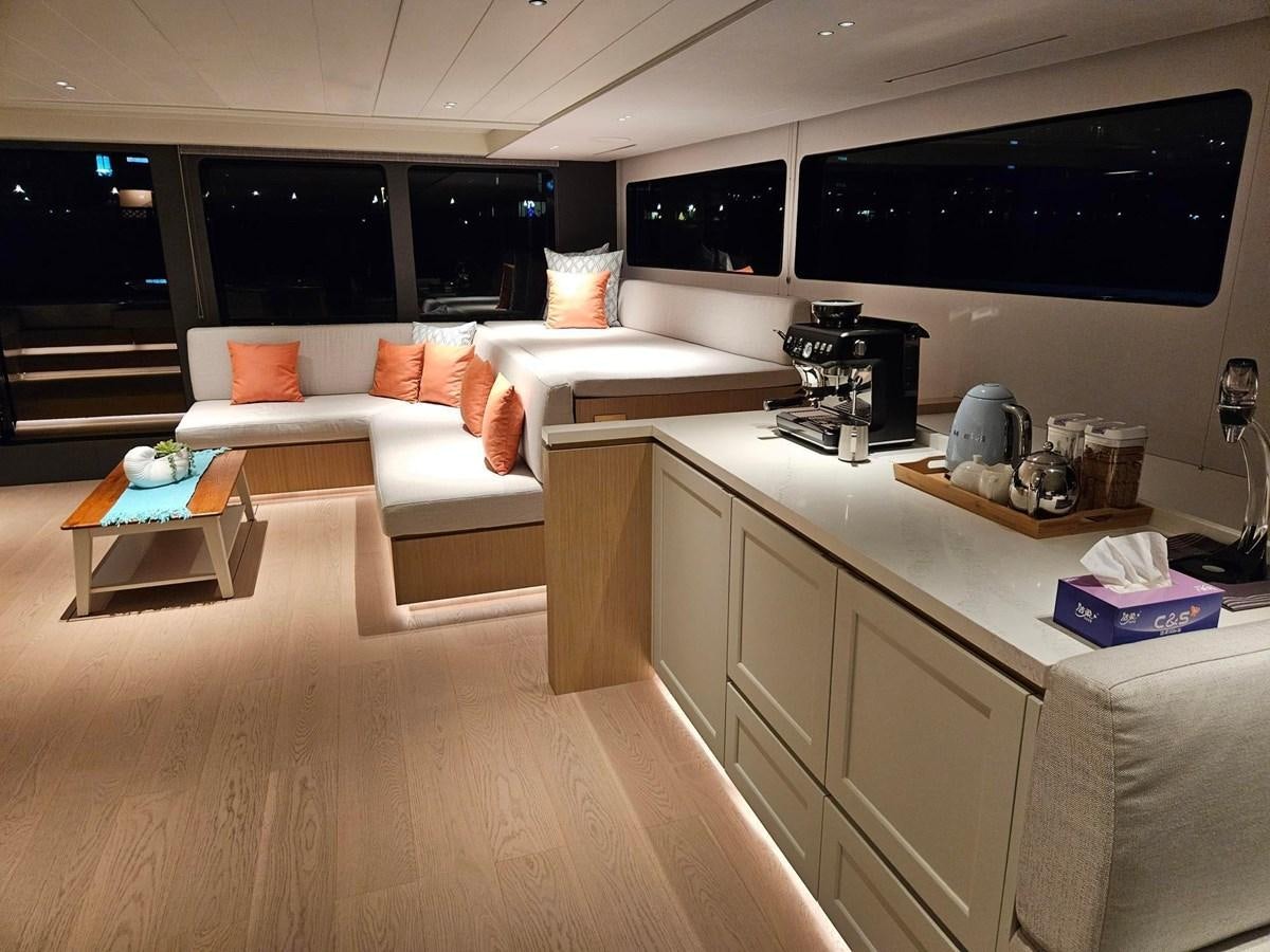 a living room with a large screen aboard BUNDALONG Yacht for Sale
