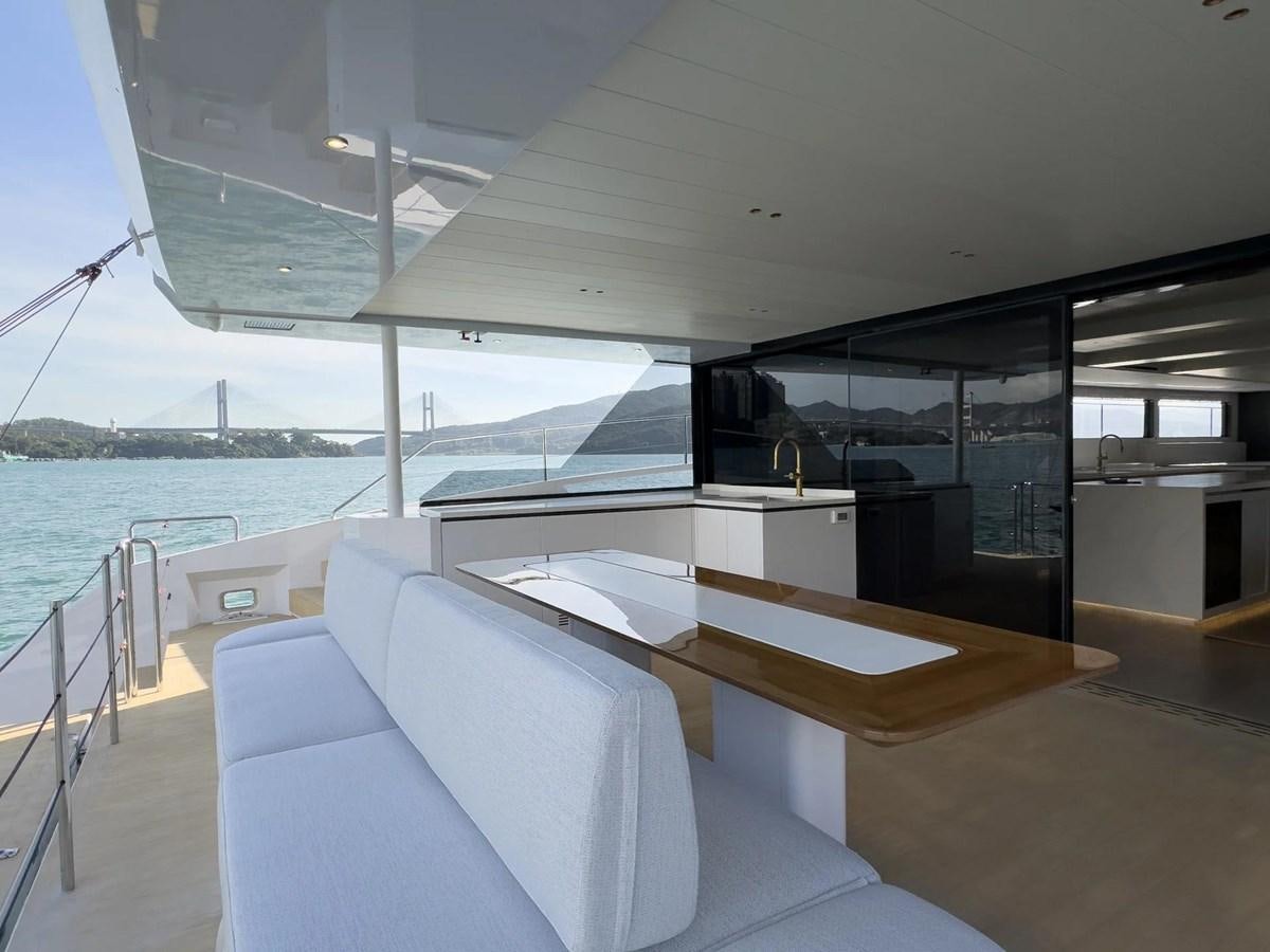 a room with a table and chairs aboard BUNDALONG Yacht for Sale