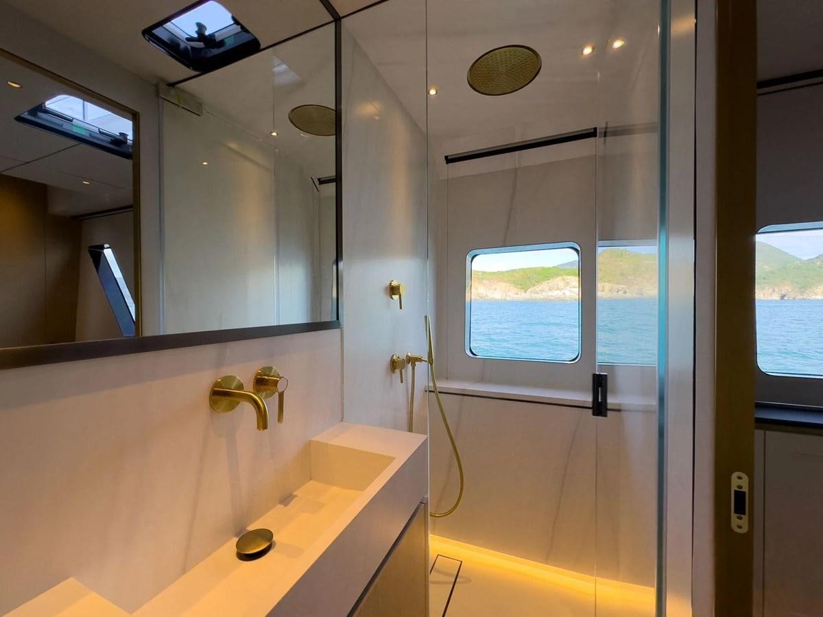 a bathroom with a glass shower aboard BUNDALONG Yacht for Sale