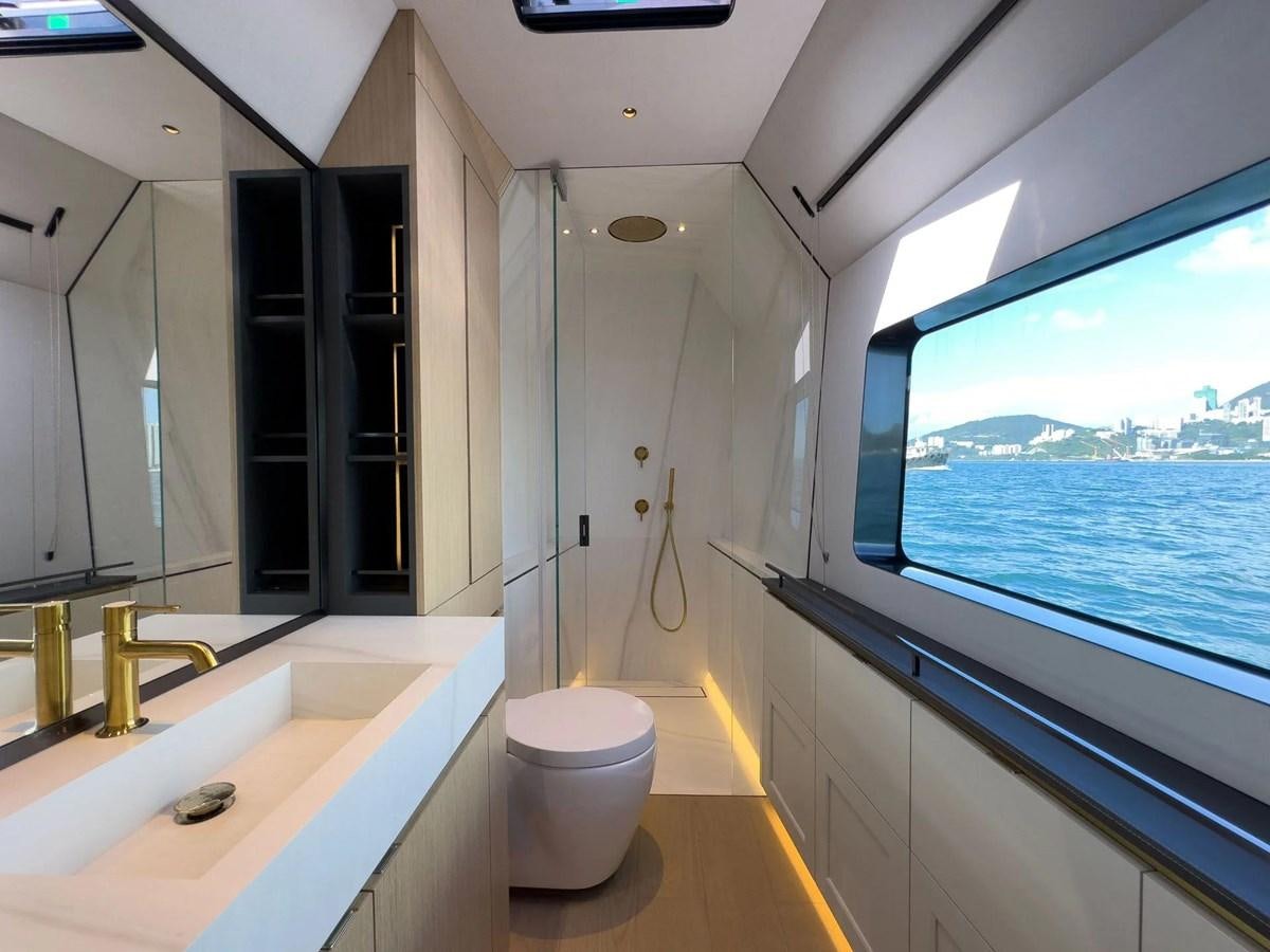 a bathroom with a large window aboard BUNDALONG Yacht for Sale