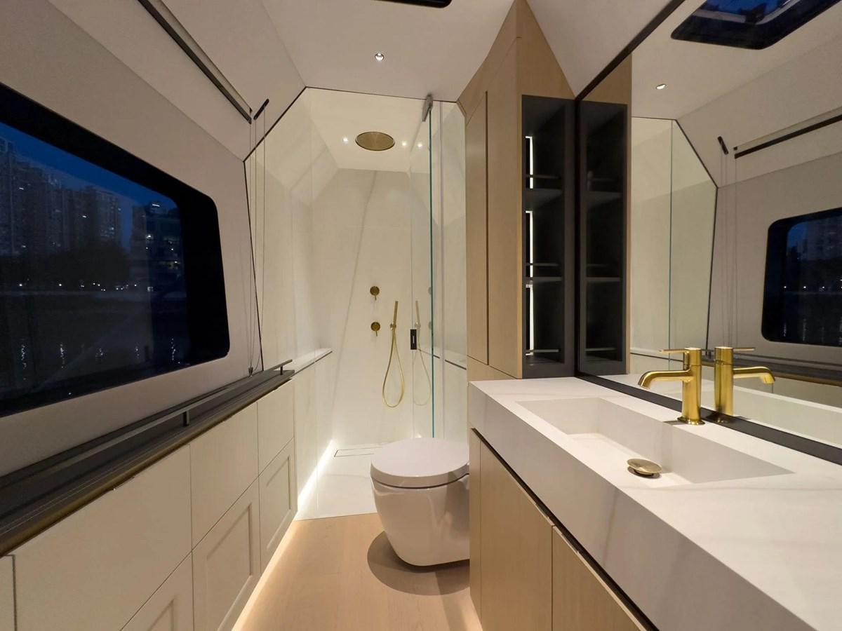 a bathroom with a large tv aboard BUNDALONG Yacht for Sale