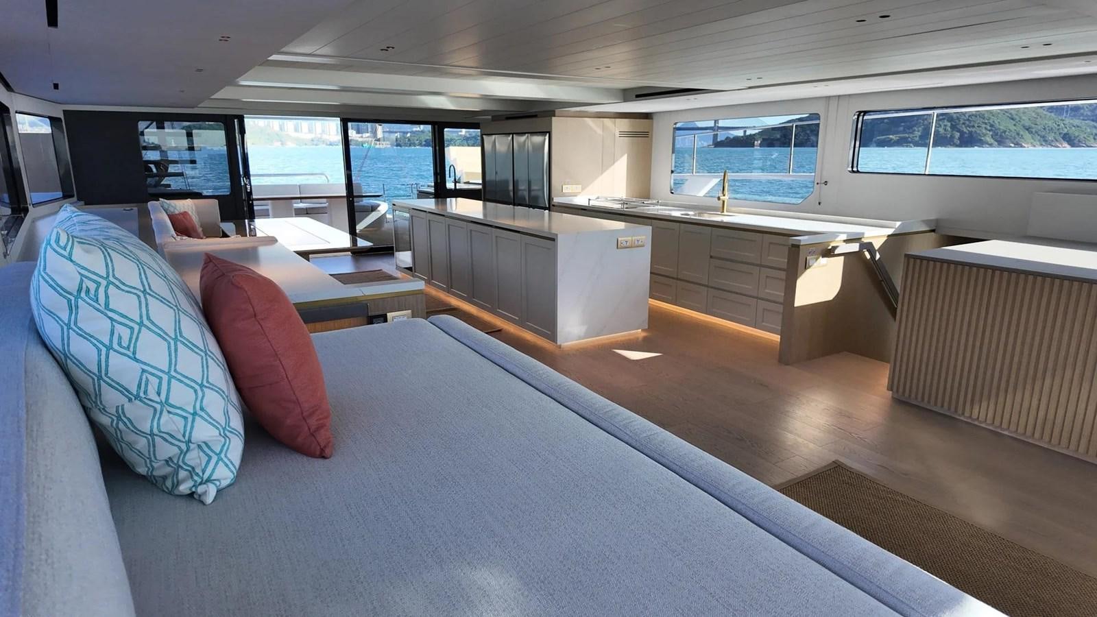 a room with a couch and a table with pillows aboard BUNDALONG Yacht for Sale