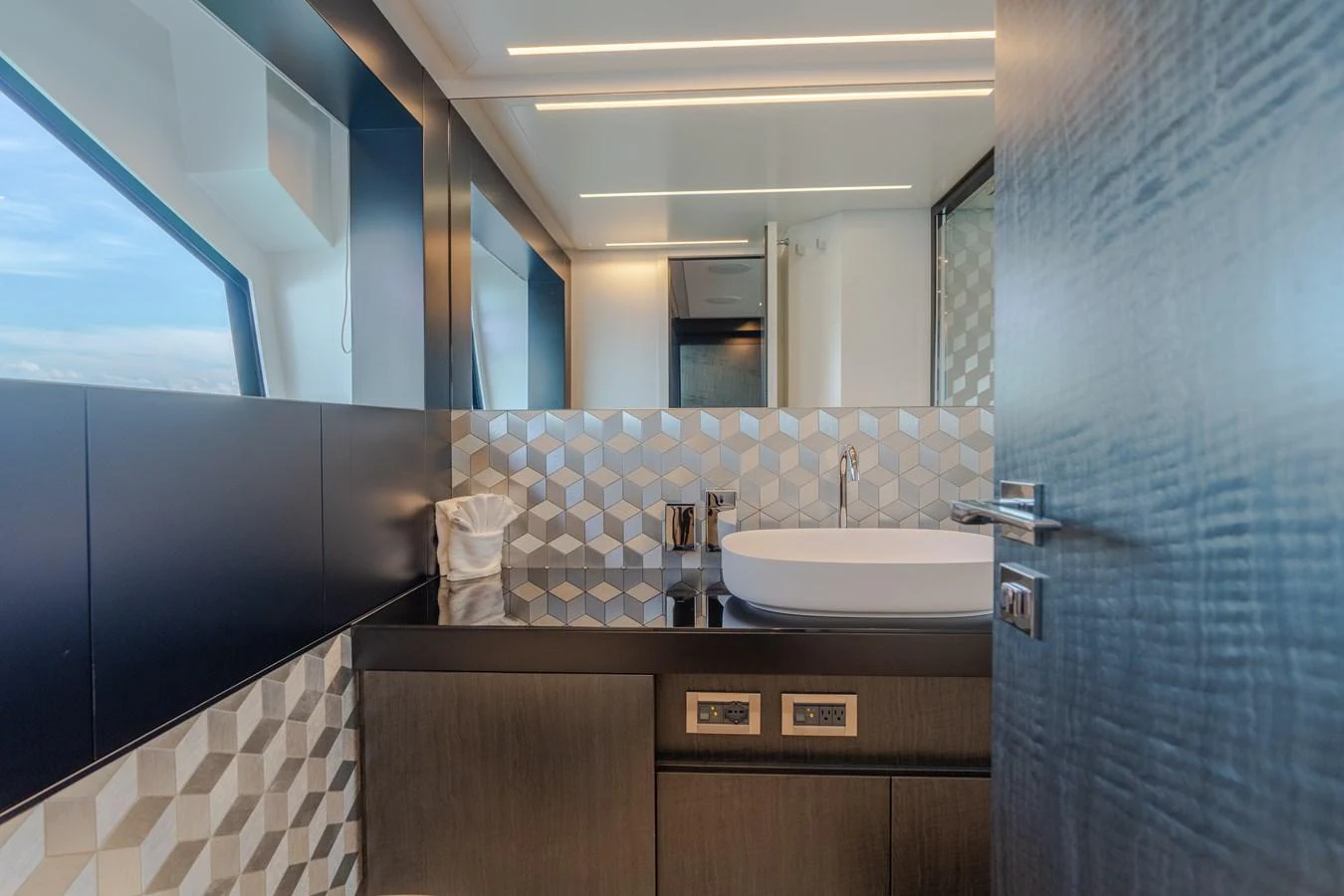 a bathroom with a sink and a mirror aboard VINTAGE Yacht for Sale