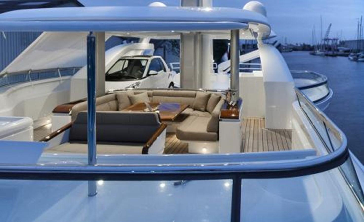 a boat with a chair on the deck aboard BDJ Yacht for Sale