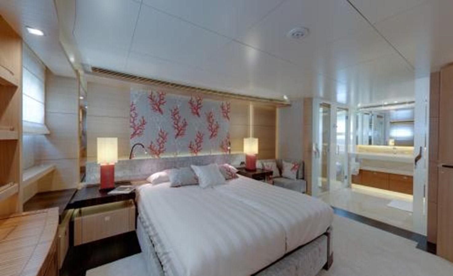 a bedroom with a bed and a lamp aboard BDJ Yacht for Sale