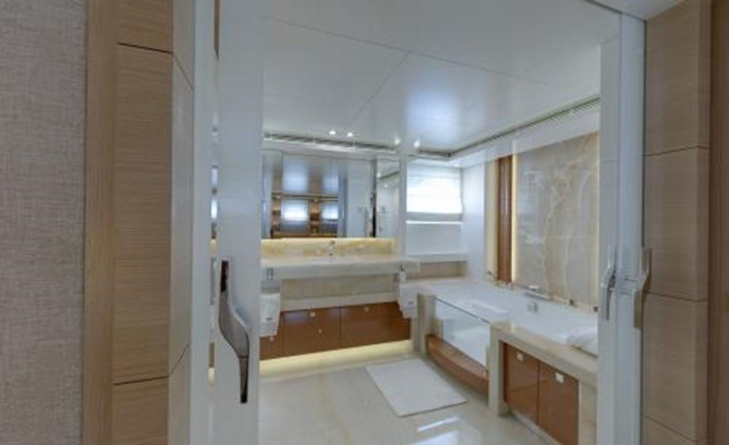 a room with a tub and sinks aboard BDJ Yacht for Sale