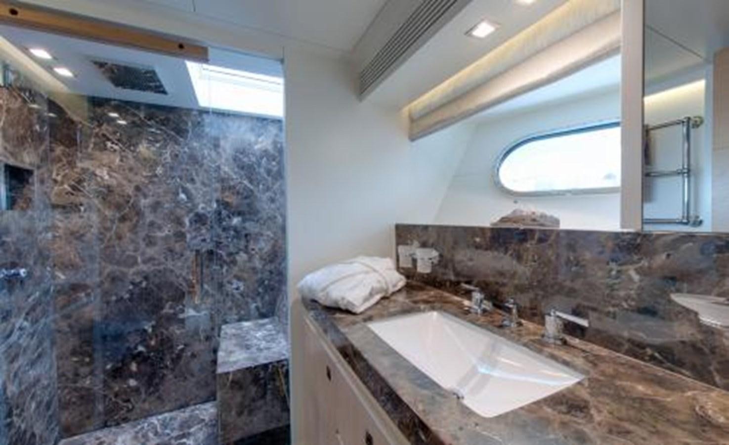 a bathroom with a rock wall aboard BDJ Yacht for Sale