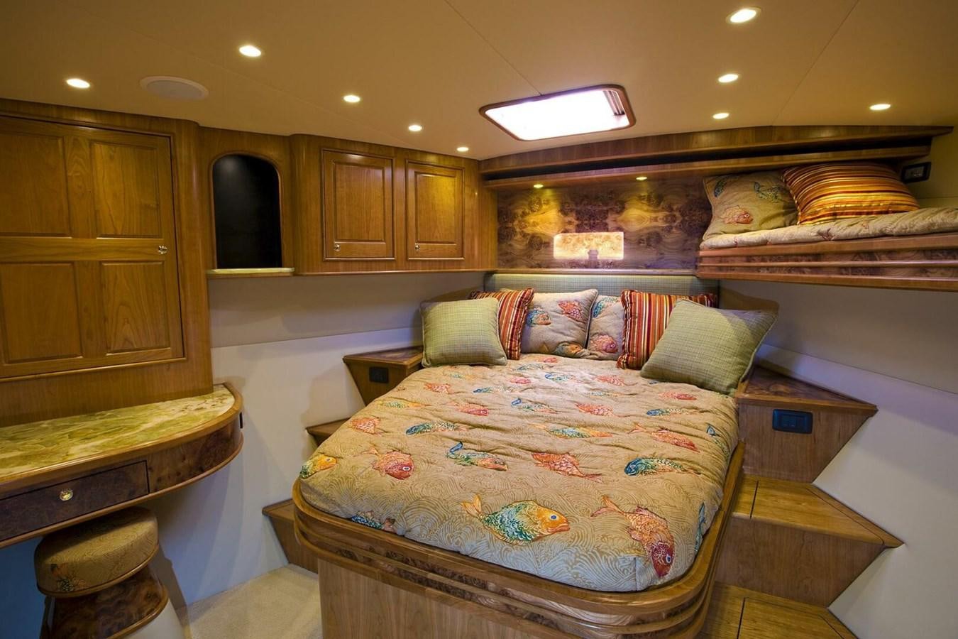 a bedroom with a bed and a dresser aboard ANN WARRICK Yacht for Sale
