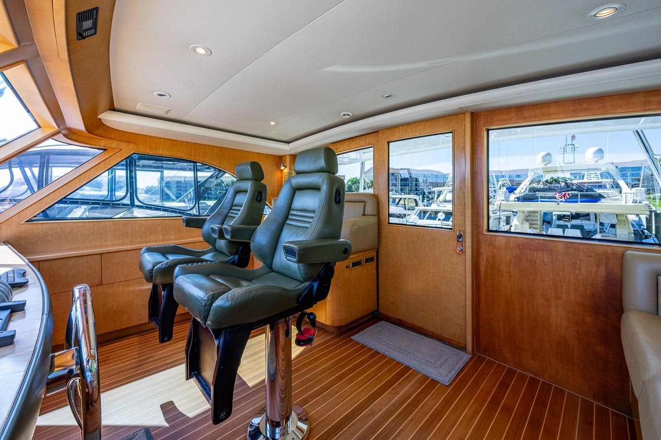 a room with a chair and a table and a window aboard DON TEO Yacht for Sale