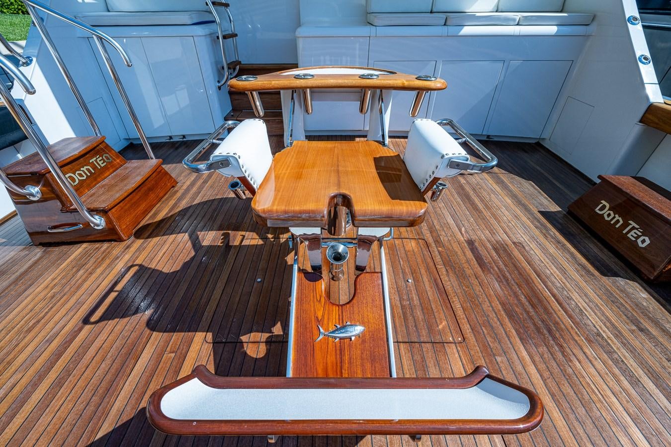 a wooden table with a wooden chair aboard DON TEO Yacht for Sale