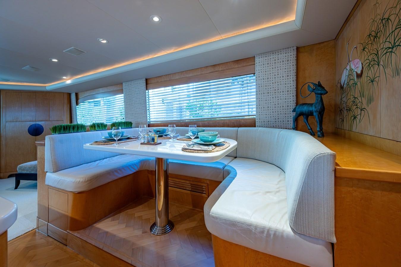 a living room with a table and couches aboard DON TEO Yacht for Sale