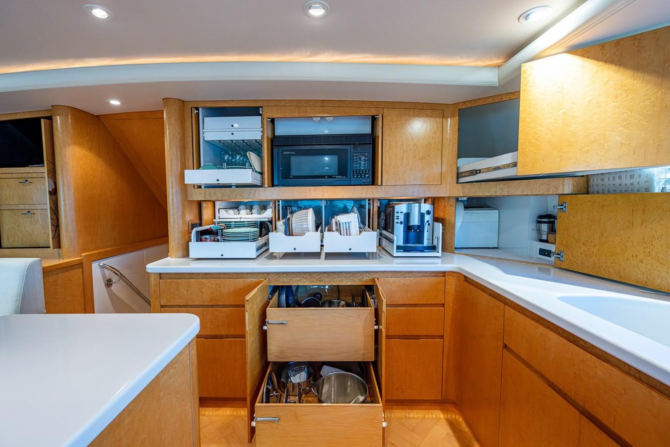 a kitchen with wooden cabinets aboard DON TEO Yacht for Sale