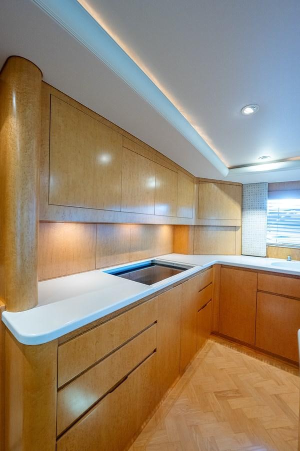 a kitchen with wooden cabinets aboard DON TEO Yacht for Sale