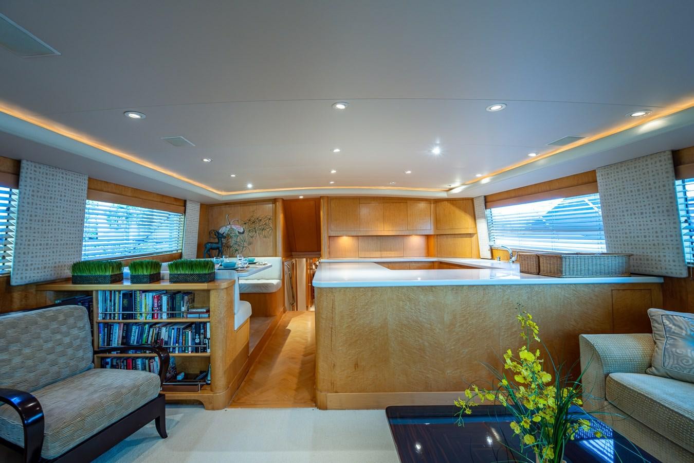 a room with a couch and a table and a shelf with books aboard DON TEO Yacht for Sale