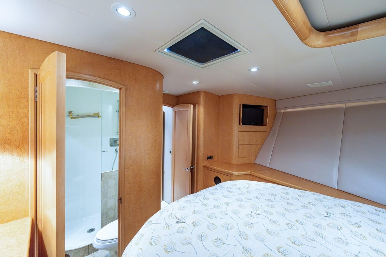 a bedroom with a bed and a television on the ceiling aboard DON TEO Yacht for Sale