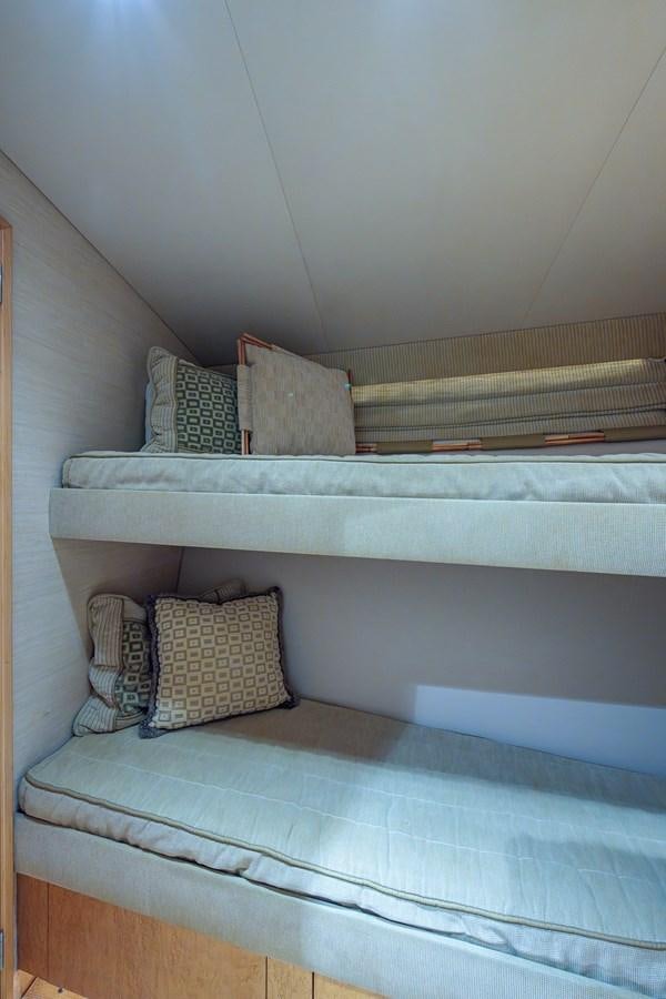 a bed with a blue sheet aboard DON TEO Yacht for Sale