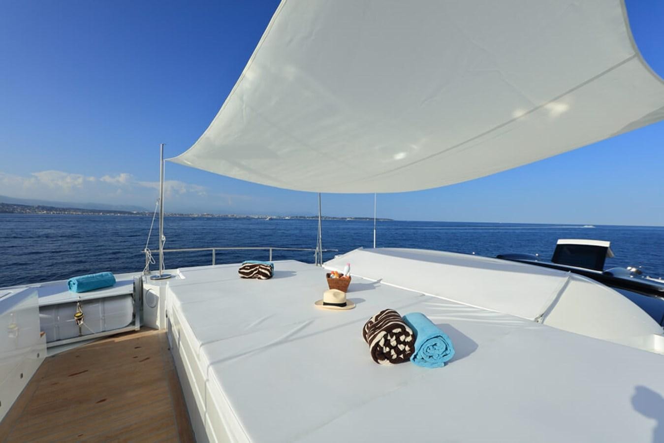 a white boat on a body of water aboard BAIA 100 Yacht for Sale